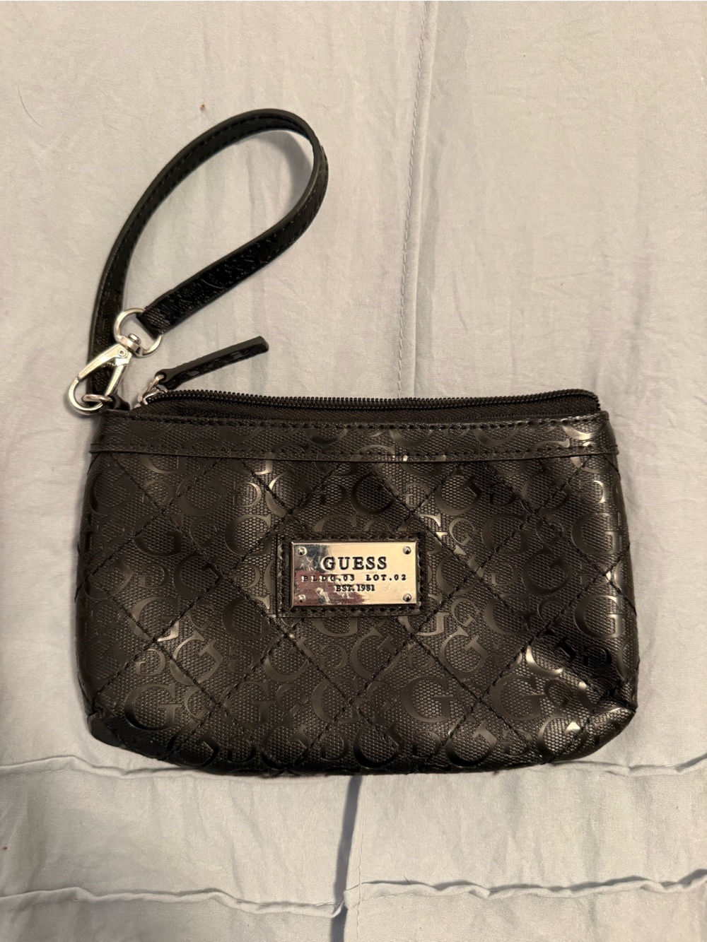 GUESS Black Quilted Logo Wristlet with Silver Plaque
